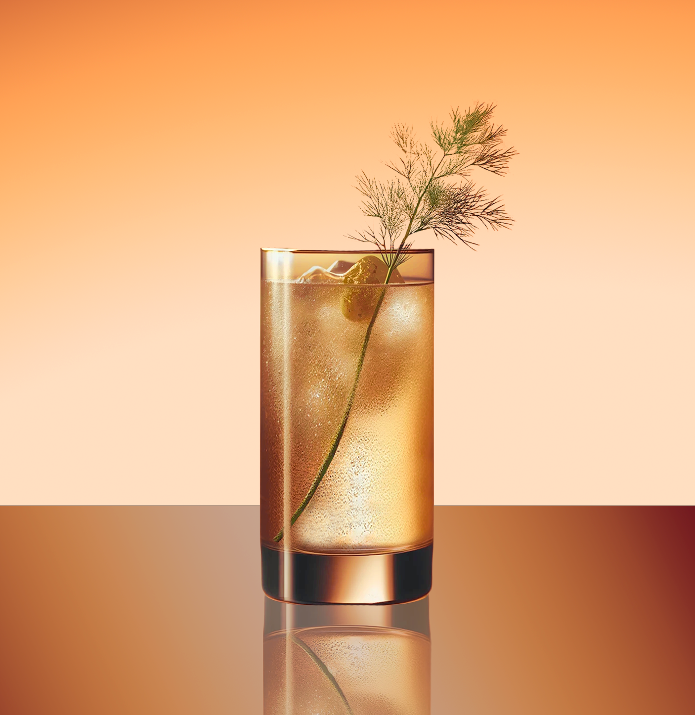 Hot Toddy Cocktail on ice in a tall highball glass with fennel sprig garnish. orange background and mirror surface