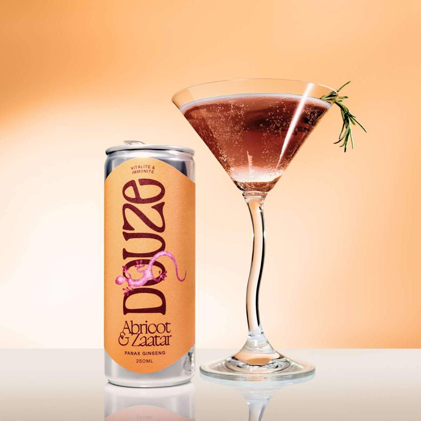A Douze drink Apricot & Za'atar can next to a full martini glass, garnished with rosemary, against a gradient background.