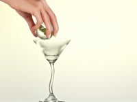 Video of woman making Poire & Anis Douze cocktail. She places an ice cube in a martini glass & pours the drink from the can.